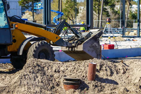 view of the construction site with construction equipment and yellow front loader