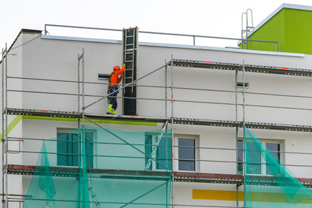demolition of scaffolding after insulation and renovation of the apartment house facade