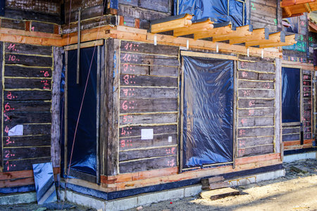restoration of an old wooden house by numbering, dismantling, assembling and replacing the damaged...