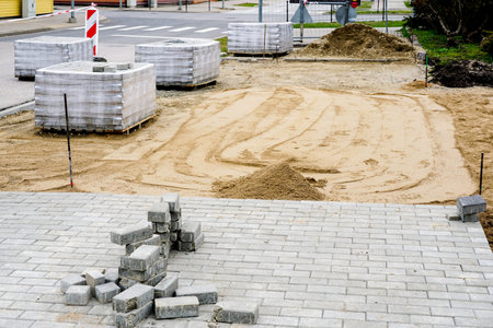 view of the pavement construction site, concrete slab pallets and the prepared gravel base