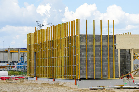 the facade of a new building built of building blocks with wooden laths for attaching thermal...
