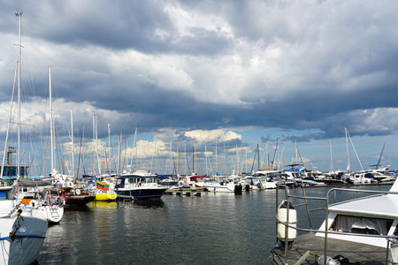 beautiful landscape with boats, sailboats and yachts on the marina bay against a background of...