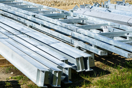 stack of various galvanized metal structures on the ground at the construction site