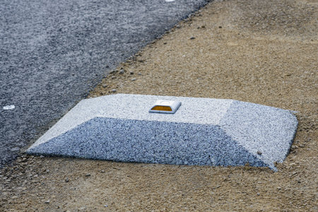 new modern roadside enclosures in the form of a concrete elevation with a yellow reflective road studの写真素材