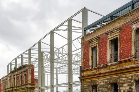 integration of the facade of the old brick building into a new modern industrial metal construction housingの写真素材