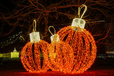 Large Christmas decoration balls at city square at evening, decorated with LED lights