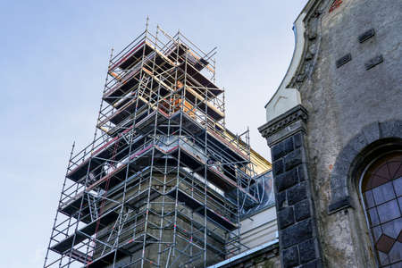 scaffolding of complicated configuration for the restoration and replacement of the roof of a historic church towerの写真素材