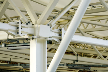 the point of connection of steel supports, beams and crossbeams in the structure of the new modern...