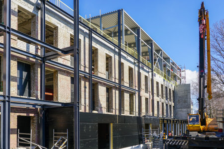 Reconstruction and modernization of an old brick building by expanding it with new metal frame...