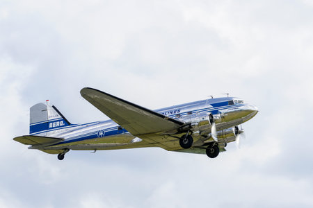 Liepaja, Latvia - August 07, 2022: Vintage Douglas DC3 passenger plane from Finland in flight over...