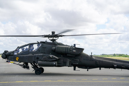 Liepaja, Latvia - August 07, 2022: AH-64D Apache attack helicopter from United States army with crew after landing at the airport runwayのeditorial素材