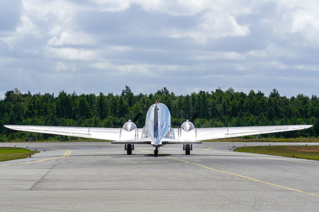 Liepaja, Latvia - August 07, 2022: Douglas DC3 plane before taking off from an airport runway, rear...
