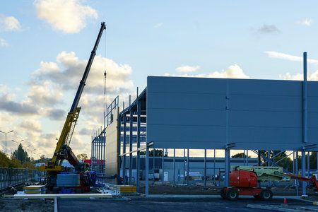 Sandwich panel facade assembly on an assembled steel frame of a new modern warehouse building