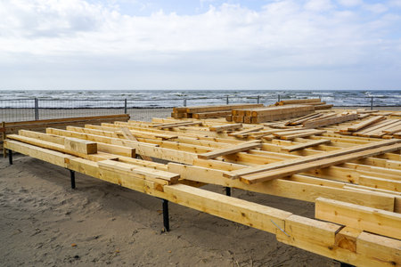 Construction of a new natural wood plank floor on the Baltic seashore for a seasonal cafeの写真素材