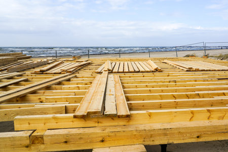 Construction of a new natural wood plank floor on the Baltic seashore for a seasonal cafeの写真素材