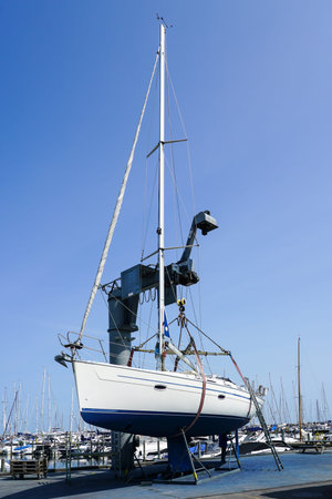 The yacht lifted ashore by a sailboat lift for the repair and maintenance of the underwater part of...