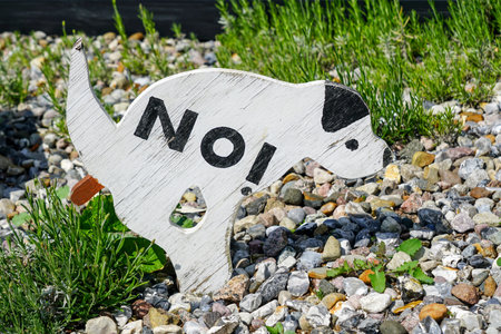 Original wooden warning sign in the form of a dog No dogs poop zone, dogs are not allowed to poop, pooping forbiddenの写真素材