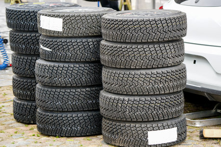 Sets of new high performance gravel rally tires, closeup of modern asymmetric tread pattern, sports...