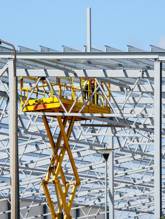 Complex large volume steel frame structure assembly using self propelled scissor lift platform, assembly of metal structuresの写真素材