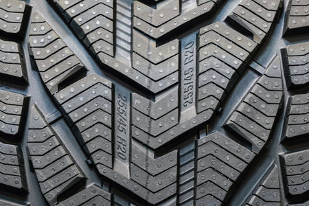 Tire tread with embossed tire size markings embedded in the tread rubber, tire design example