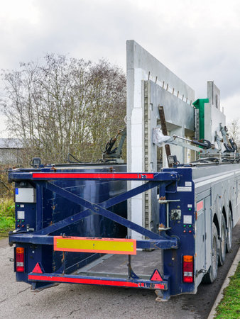Transportation of reinforced concrete precast wall panels for house construction with a specialized low loader semi-trailer, hydraulically secured loadの写真素材