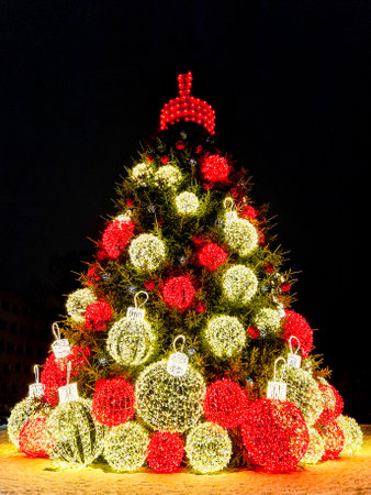 A gorgeous large Christmas tree in the town square at night, decorated with large LED light balls, Liepaja, Latviaの写真素材
