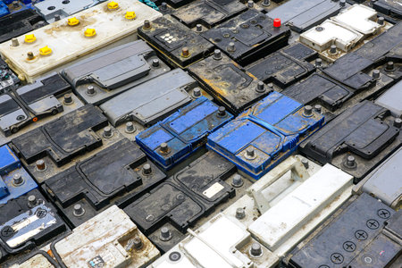 Stack of many used car batteries for recycling in a hazardous waste facility, used car batteries...