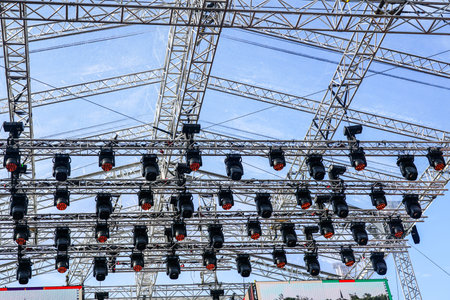 Fragment of metal trusses and lighting elements of a large outdoor stage, aluminum concert stage...