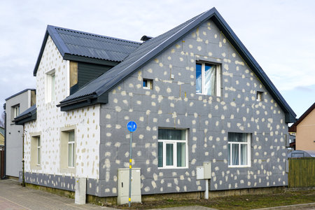 Thermal insulation of the facade of a residential building with modern thermal insulation material plates, wall heat insulation, heat saving measuresの写真素材