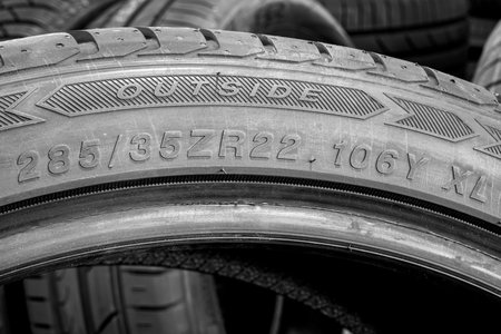 Side view of a large size high performance tire with an indication of tire width, height and...