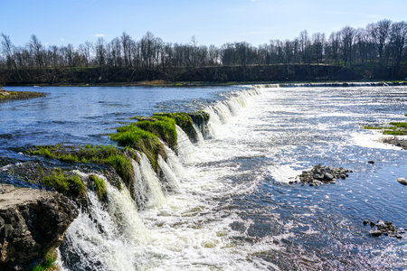 Ventas river waterfall or Ventas rumba in Kuldiga, Latvia, Europe, sunny early spring landscape, the widest waterfall in Europeの写真素材