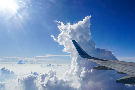 Soaring Above the Clouds, A Stunning Aerial View from a Plane Window with Towering Cumulus Clouds,...