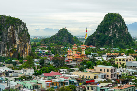 Panoramic landscape of Vietnam Marble Mountains near Da Nang featuring a vibrant pagoda, Buddhist...