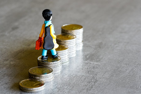 A small figurine carrying a guitar and suitcase walks up rising euro coin stacks, representing ambition, career growth, and financial steps to successの写真素材