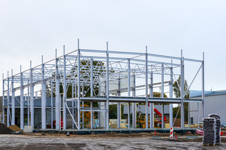 Steel frame structure of a modern industrial building under construction. Civil engineering and infrastructure development concept with metal beamsの写真素材