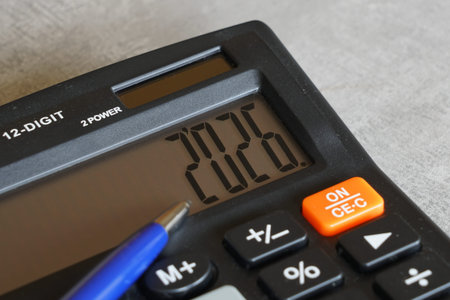 Close-up of a calculator displaying 2026 with a pen, symbolizing upcoming year planning, business forecasting, budgeting, and financial preparation for 2026の写真素材