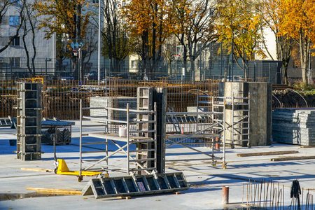 Concrete foundations and reinforced steel framework for new apartment building under construction in Latvia, showing early stages of urban developmentの写真素材