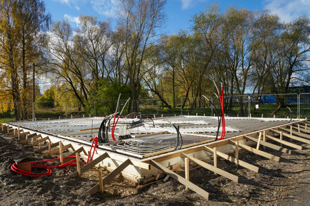 Underfloor heating pipes installed in concrete base at new house construction site, energy-efficient heating system and modern building technologyの写真素材