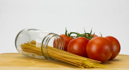 Fresh tomatoes and whole wheat spaghetti in mason jarの写真素材