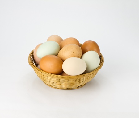 Free range chicken eggs in wicker basketの写真素材