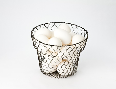 Fresh free range eggs in vintage wire egg basketの写真素材