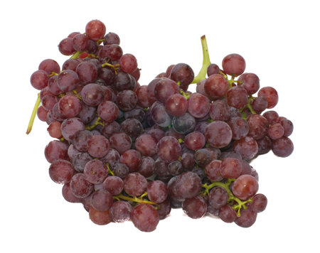 Bunches of fresh picked seedless red grapes isolated on white