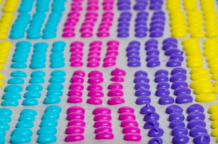 A tray of colorful homemade candy dotsの写真素材
