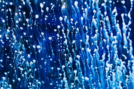Blue water with white bubbles as an abstract backgroundの写真素材