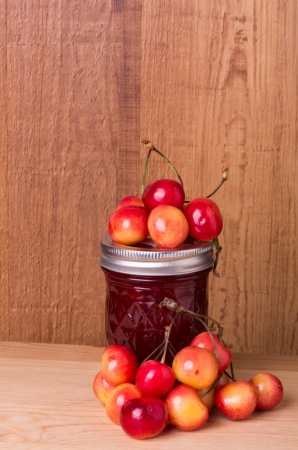 Fresh cherry jam or jelly with cherries on wooden tableの写真素材