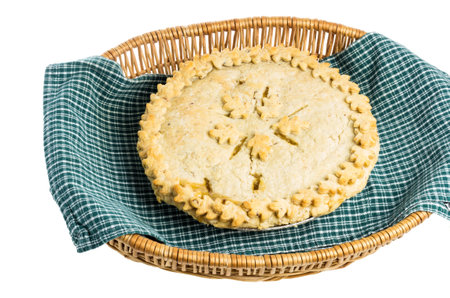 Homemade fresh peach fruit pie in a wicker basket with cloth