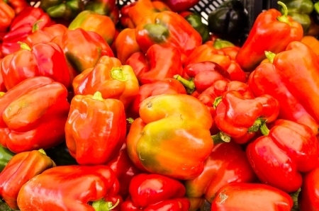 Fresh red bell peppers on display at the marketの写真素材