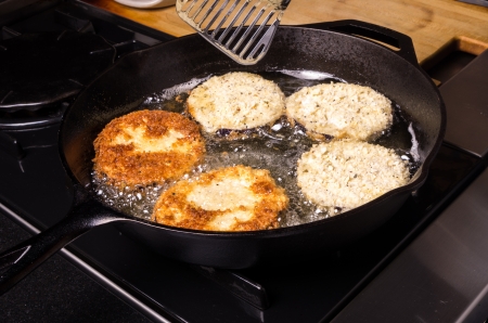Frying slices of eggplant in cast iron skilletの写真素材