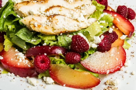 A fresh salad with chicken raspberries and feta cheeseの写真素材