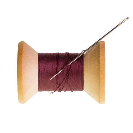 Spool of red sewing thread isolated on white